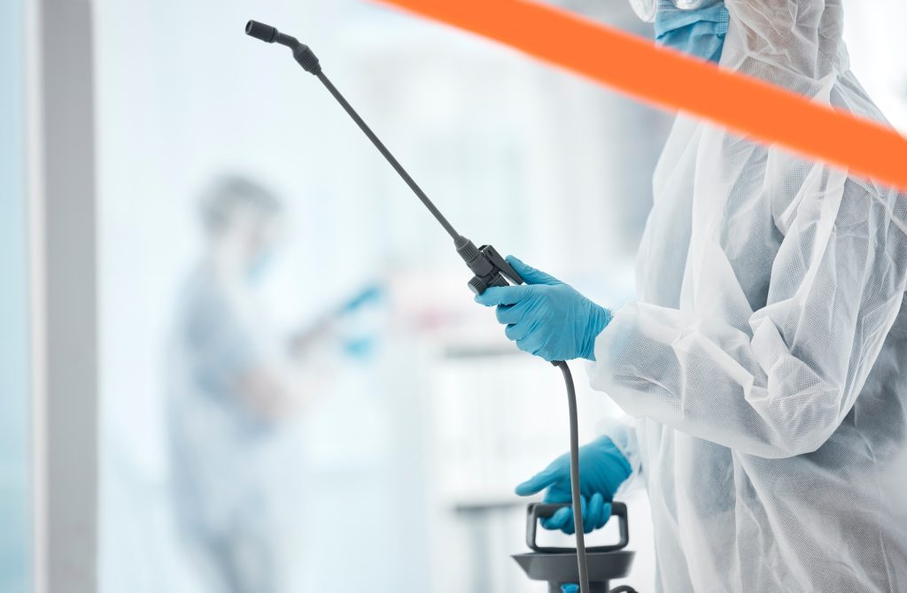 Hospital, cleaning and covid sanitation by professional cleaner spray, disinfect and bacteria preve
